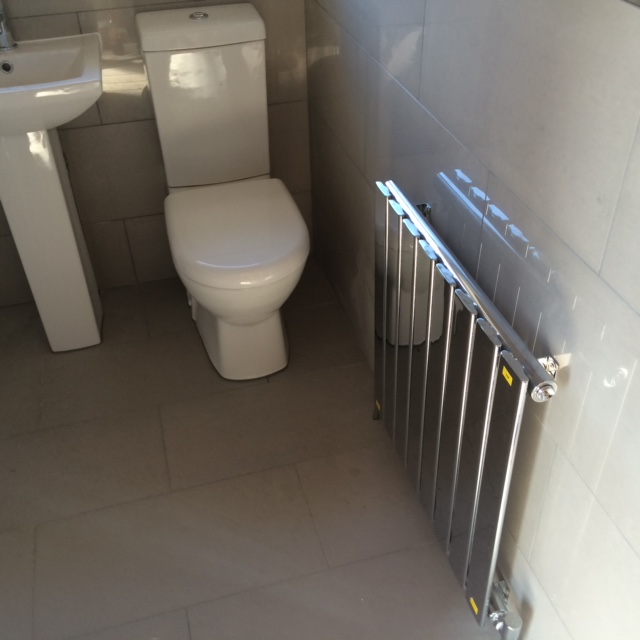 Image of a radiator and toilet installation from JR40 Plastering in Northampton