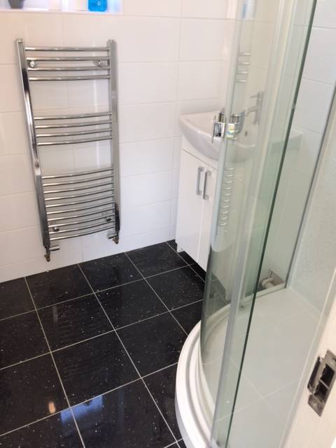 Image showing wall and floor bathroom tiles installed by JR40 Plastering