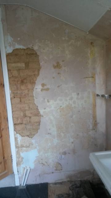 before photo of exposed brick wall