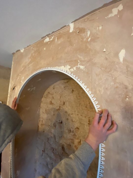 image of a man measuring up for plastering