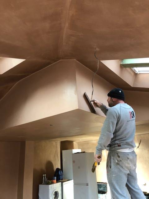 image of a man plastering